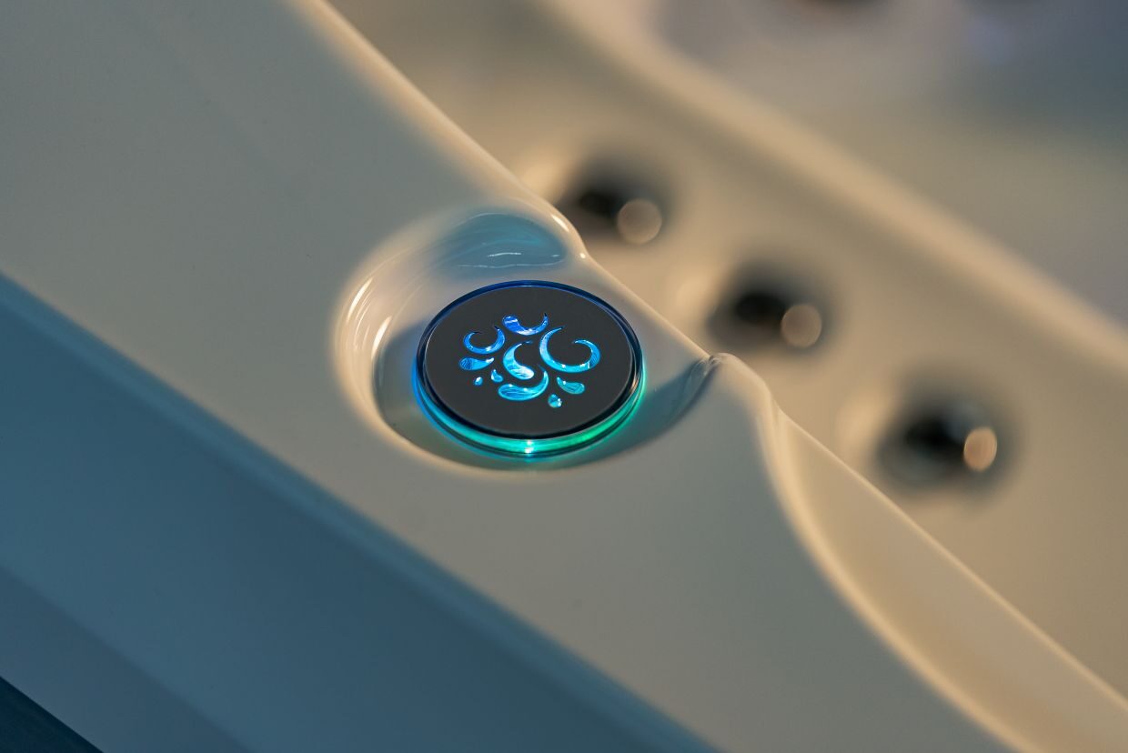 Verlichte knop op bad met waterdruppel symbool